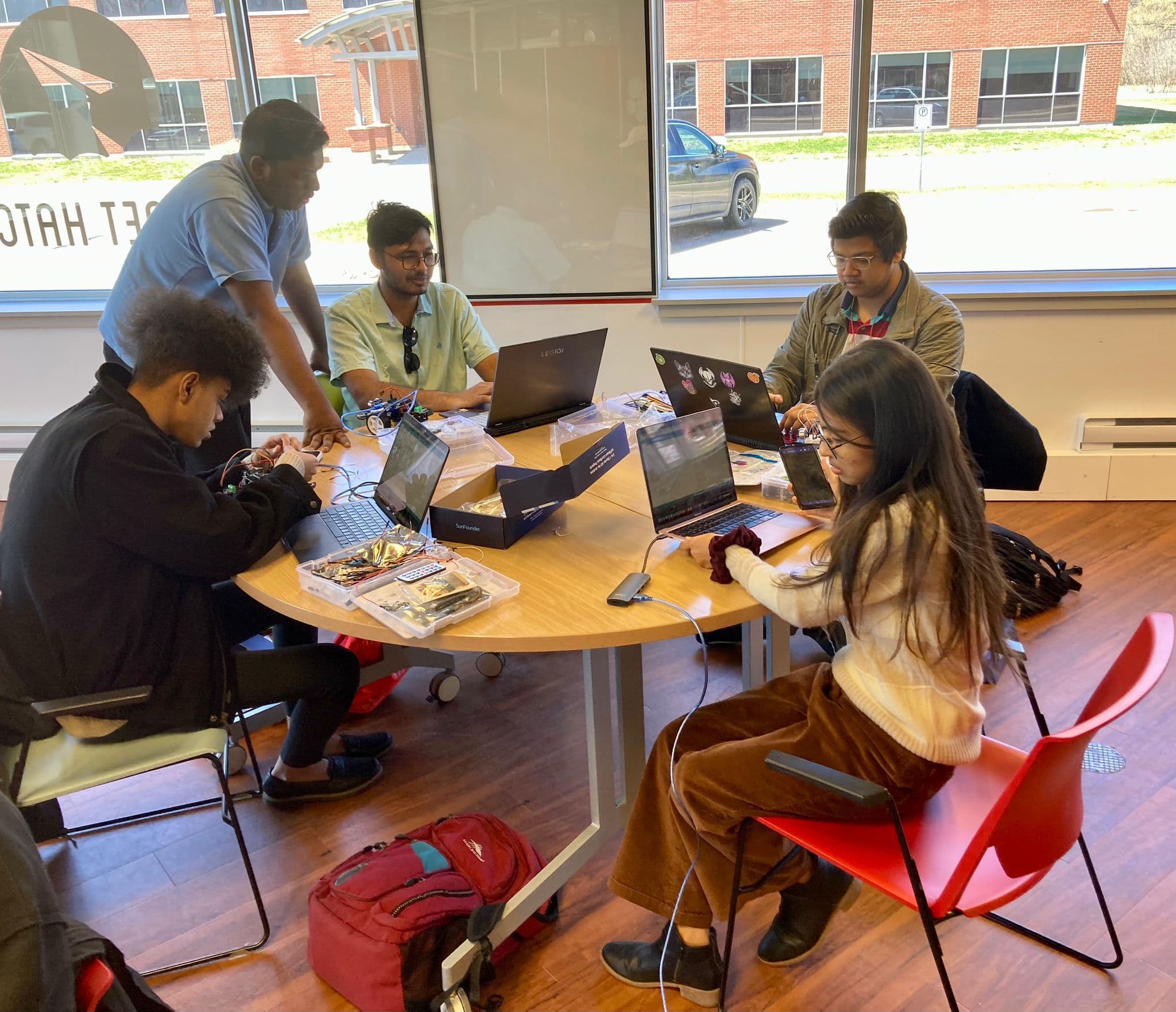 Students building robot components